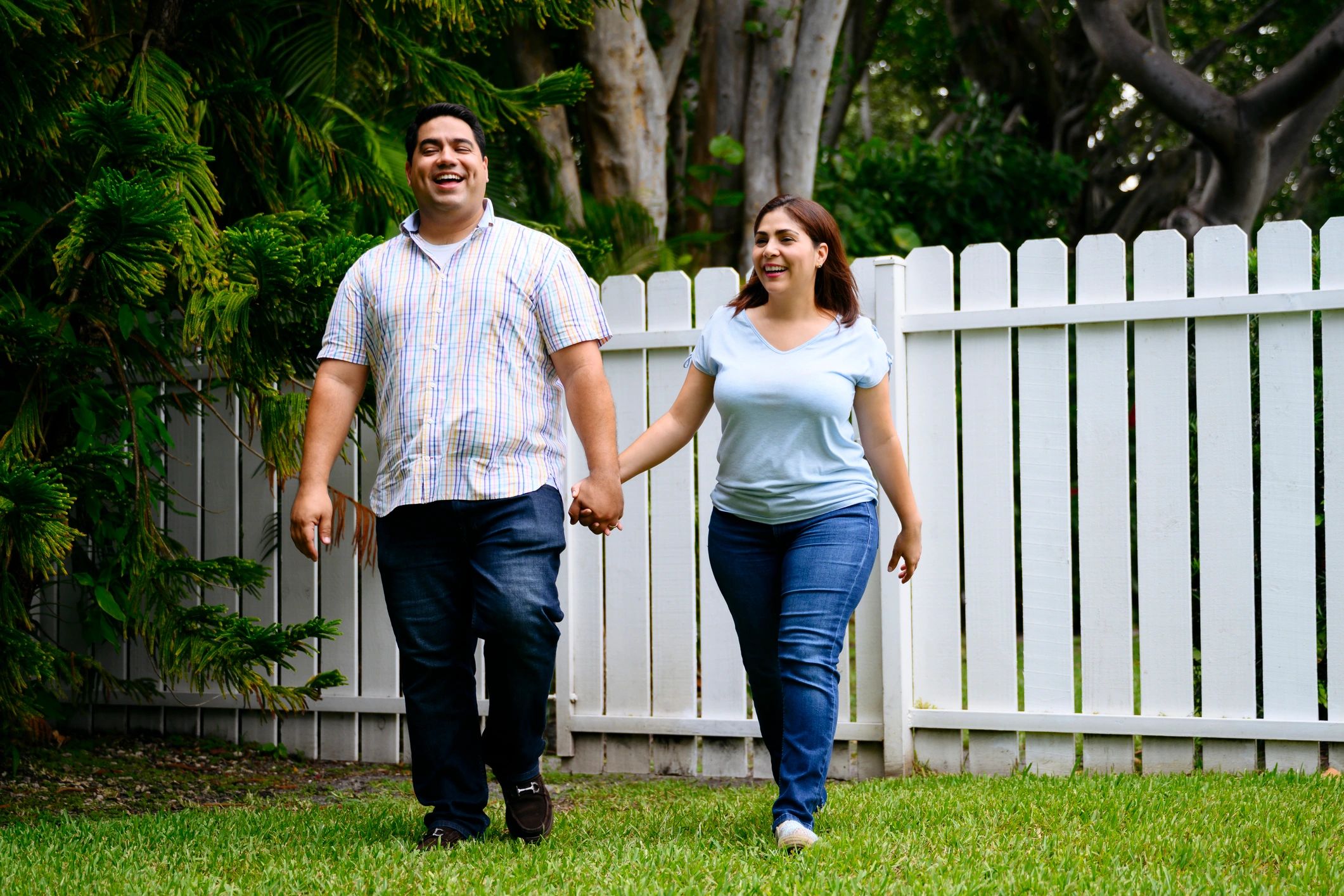 Happy homeowners outside a Miami-area home
